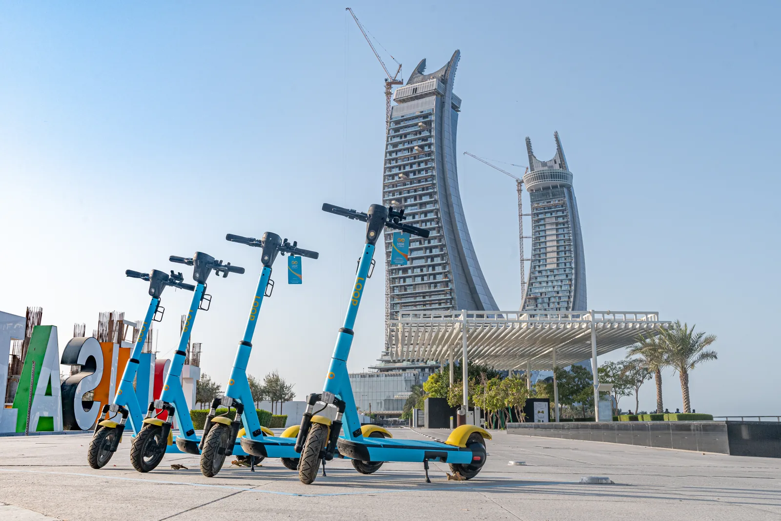 Four Loop scooters lined up together in a Qatar plaza